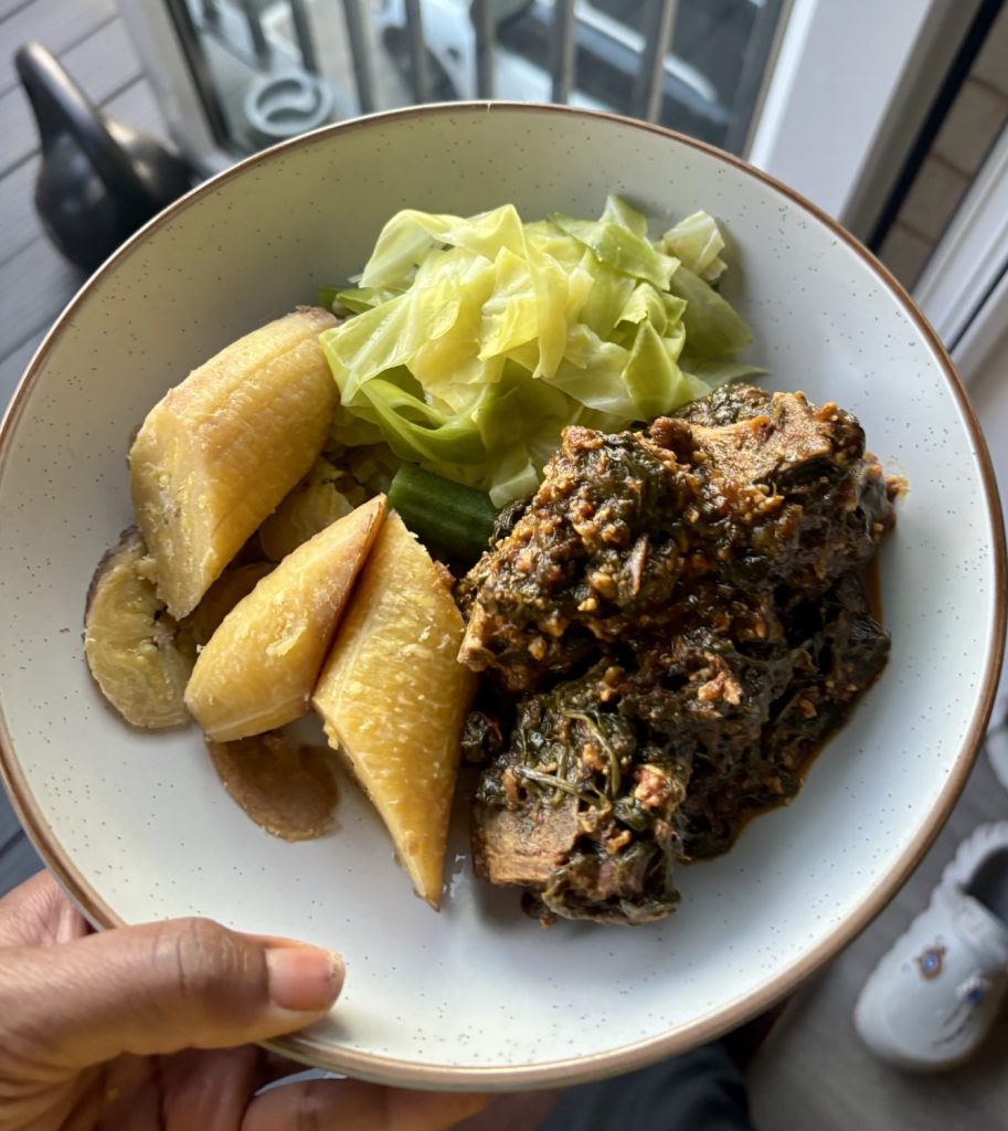 Boiled plantain with spinach and oxtail stew and spring greens